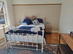 a bedroom with a white bed and a window at Beachside Terrace in Dovercourt