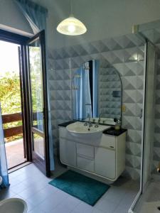 a bathroom with a sink and a mirror at Villa Ginevra in Bagnaia