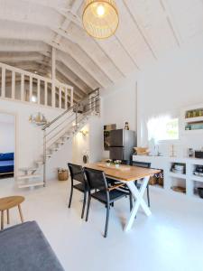 a kitchen and dining room with a table and chairs at Lux Natura in Prinos