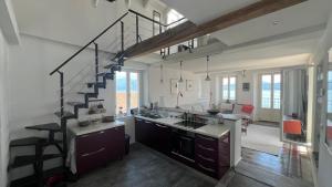 a kitchen with a spiral staircase in a house at Schwalbenhaus in Oggebbio