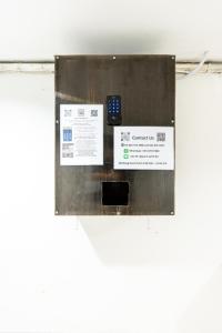 a sign with a cell phone on a wall at X Oh My Nap BTS Nana - โอ้ มาย แน็ป บีทีเอส นานา in Bangkok