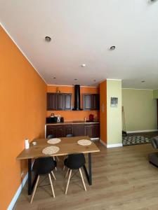a kitchen and dining room with a table and chairs at Libau Apartment in Liepāja