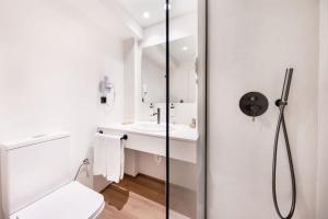 a bathroom with a shower and a toilet and a sink at Hotel Ankaa - Adults Only in Porto Cristo