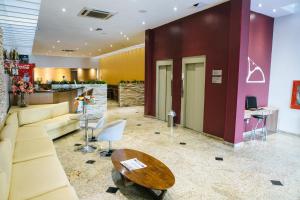 a lobby with a couch and a table and a bar at Pompeu Rio Hotel in Rio de Janeiro