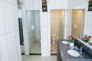 a bathroom with two sinks and a toilet at Hospedagem Ledo in Rio de Janeiro