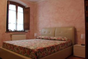 A bed or beds in a room at Lady Frantoio Toscano