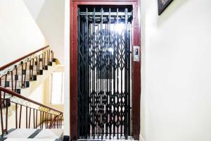 a door with a wrought iron gate in a staircase at Collection O Railway Station formerly Hotel Okasu in Raipur