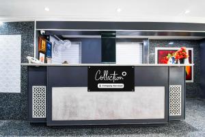 a reception desk in a building with a sign on it at Collection O Railway Station formerly Hotel Okasu in Raipur
