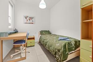 a bedroom with a bed and a desk and a desk at Apartments Kana in Pula