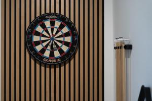 a dart board hanging on a wall at Zabłocie Comfort House with parking and garden in Kraków