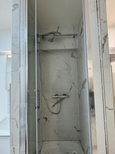a shower with a glass door in a bathroom at Paris 16, Lux Studio - Steps from metro 9! in Paris