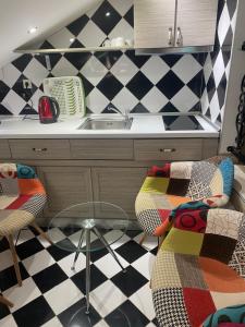 a kitchen with a sink and a table and chairs at Blue Sky Apartments in Skala Potamias