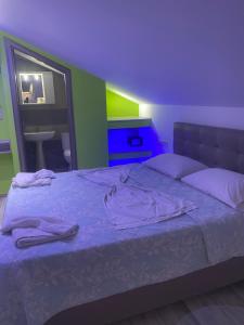 a bedroom with a bed with a purple ceiling at Blue Sky Apartments in Skala Potamias
