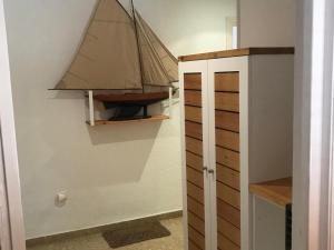 a small sail boat on a wall next to a closet at Apartamento encantador con piscina y aire acondicionado cerca de la playa de Jávea - ES-160-7 in Jávea +9 photos