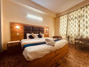 a bedroom with a large bed in a room at Antriksh cottage Manali in Manāli
