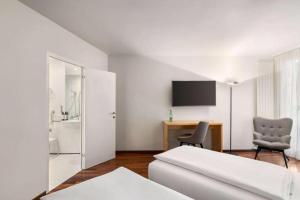 Llit o llits en una habitació de Vienna House by Wyndham Martinspark Dornbirn