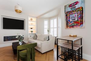 a living room with a couch and a table at 111 By Mayfair - Luxurious 12 Bedroom House, Portrush in Portrush