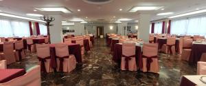 a banquet hall with tables and chairs in a room at Hotel Santomé in Sanxenxo