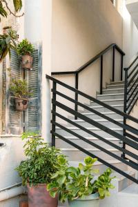 a staircase with potted plants on the side of a building at Peacock's Apartments in Piraeus +41 photos