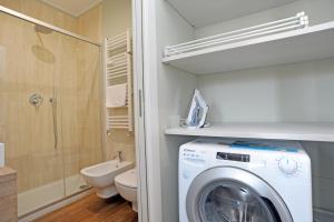 een badkamer met wasmachine en toilet bij Via Torino Apartment 3 in Milaan +16 foto's