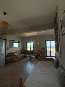 a living room with a couch and a table at Sunset Apartments in Evdilos