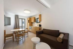 a living room with a couch and a table at Azure Naousa in Naousa