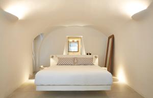 ein Schlafzimmer mit einem weißen Bett in einem weißen Zimmer in der Unterkunft Villa Aura in Firostefani