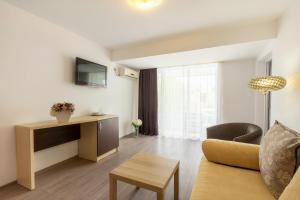 a living room with a couch and a table at Hotel Venus in Mamaia