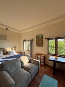 a living room with a bed and a couch at Mango 5 Hotel in Amed +168 photos