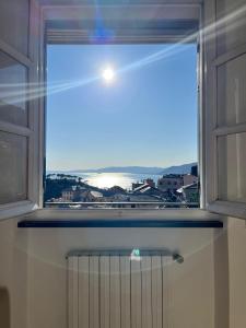 a window with a view of the ocean at Sea-view apartment with balcony & free private parking, Camogli in Camogli