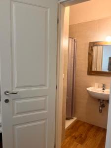 a bathroom with a white door and a sink at Il Nido tra le Mura Polignano in Polignano a Mare +33 photos