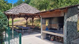 a pavilion with a grill and a table and a picnic table at Royal Haven  +22 photos