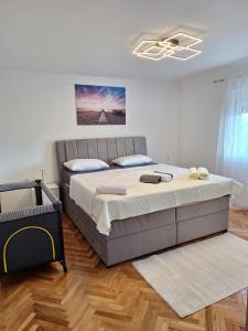 a bedroom with a large bed in a room at new renovation House Dinov San in Blato na Cetini
