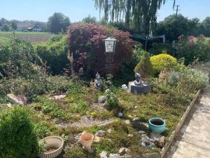 a garden with a street light and some plants at Bockhorn Farmhouse in Bockhorn