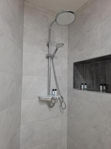 a shower with a shower head in a bathroom at new renovation House Dinov San in Blato na Cetini