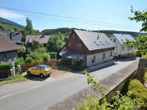 a yellow car parked in front of a house at Modern Holiday Home in Cerný Dul with Private Garden in Cerny Dul