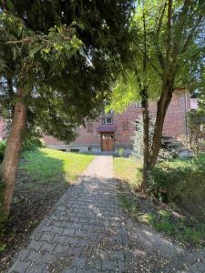 a stone path leading to a brick building with a door at Apartament Iasmina 2 in Petroşani