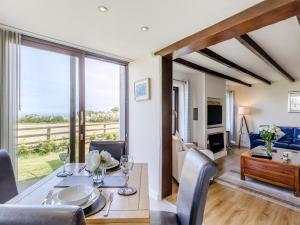 a dining room with a table and chairs and a living room at Bay View Cottage in Llanon +18 photos