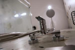 a bathroom sink with a chrome faucet at Grand Terrace 4 by Vallettastay in Valletta
