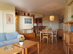 a living room with a blue couch and a table at Medas Park 261 - L'Estartit, Centro - ES-323-89 in Torroella de Montgrí