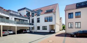 a building with two cars parked in a parking lot at Elisabeth Hotel garni in Detmold