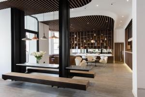 a dining room and kitchen with a table and chairs at Mowbray Court Hotel in London