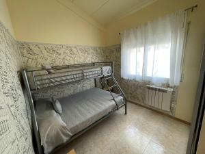 a bedroom with a bunk bed and a window at Casa con Piscina, Cerca de la Playa y del Centro - L'Estartit - ES-323-32 in L'Estartit +14 photos