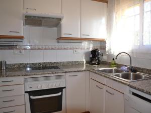 a kitchen with white cabinets and a sink at Casa con Piscina, Cerca de la Playa y del Centro - L'Estartit - ES-323-32 in L'Estartit