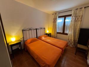 ein Schlafzimmer mit zwei Betten und einem Fenster in der Unterkunft Casa con Gran Jardín Privado y Piscina Comunitaria en Torroella de Montgrí - ES-323-44 in L'Estartit + 28 Fotos