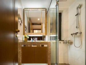 a bathroom with a shower and a sink and a mirror at Fsmile Viessmann City Resort Suites in Chongqing