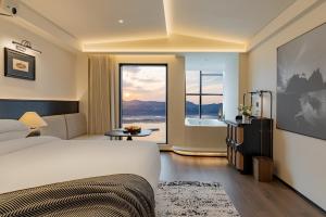a hotel room with a bed and a bath tub at Fanjü 1790 Urban Homestay in Yichang