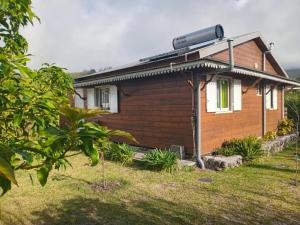a house with a solar panel on the side of it at Le chal'heureux in La Plaine des Palmistes