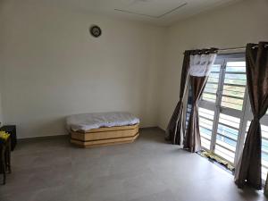 a bedroom with a bed and a window at Rolling Hills in Nashik