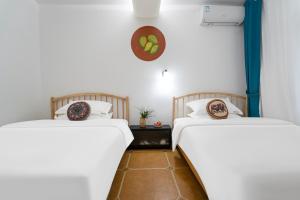 Postel nebo postele na pokoji v ubytování Mangshi Dianshan Xiyuan Homestay